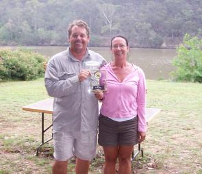 Champion female angler Kim Moller receives her trophy from HNBAA president Tony Devine.